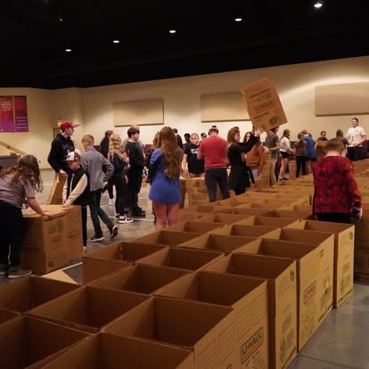 Church volunteers arranging rows of food boxes